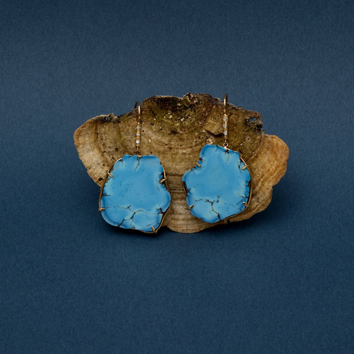 Turquoise Earrings against wood
