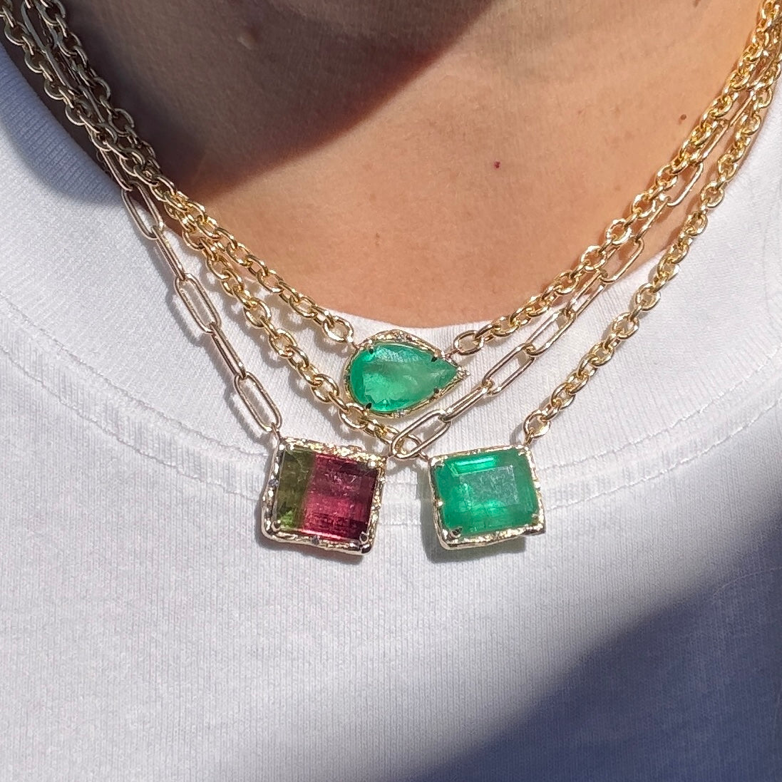 Necklace with green and red gemstones on a white background
