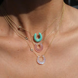 Necklace with colorful circular pendants on a person's neck
