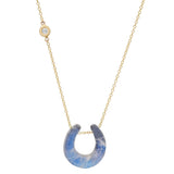 Necklace with a blue stone pendant on a gold chain against a white background