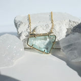 Aquamarine Horizontal Pavé Thorn Necklace photographed on a white background of rocks and crystals