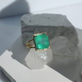 Brazilian Emerald Willow Double Band Ring photographed on a white stone background