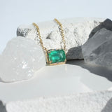 Brazilian Rectangular Emerald Willow Necklace photographed on a white background of crystals and rocks