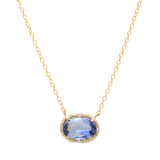A gold chain necklace with an oval pendant featuring a light blue gemstone and small clear accent stones, shown on a plain white background.