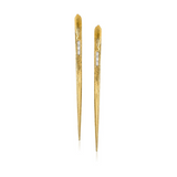 Gold hair sticks with clear gemstones on a white background